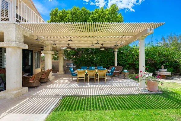 a view of a patio with couches table and chairs and potted plants