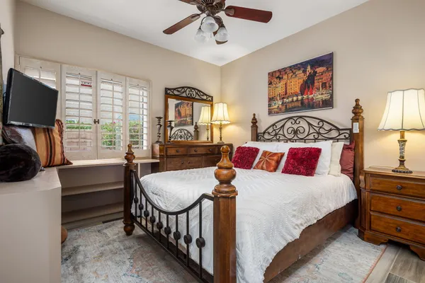 a bedroom with a bed and the painting on the wall