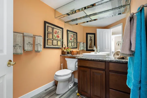 a spacious bedroom with a bed and a flat screen tv