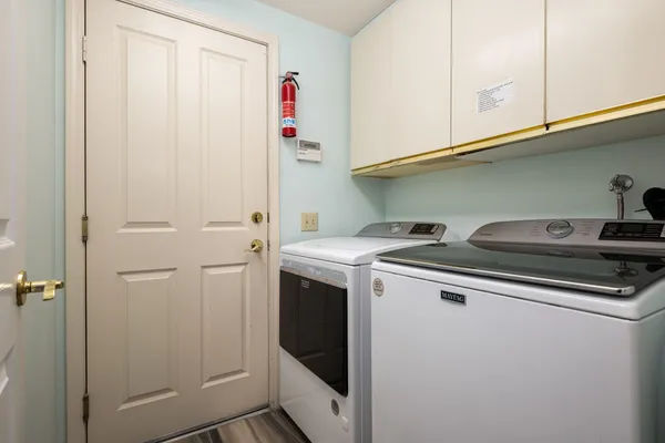 a living room with granite countertop furniture a fireplace and a large window