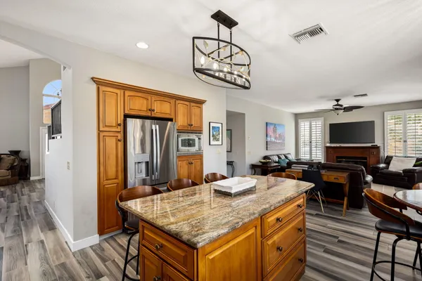 a living room with furniture a large window and a flat screen tv