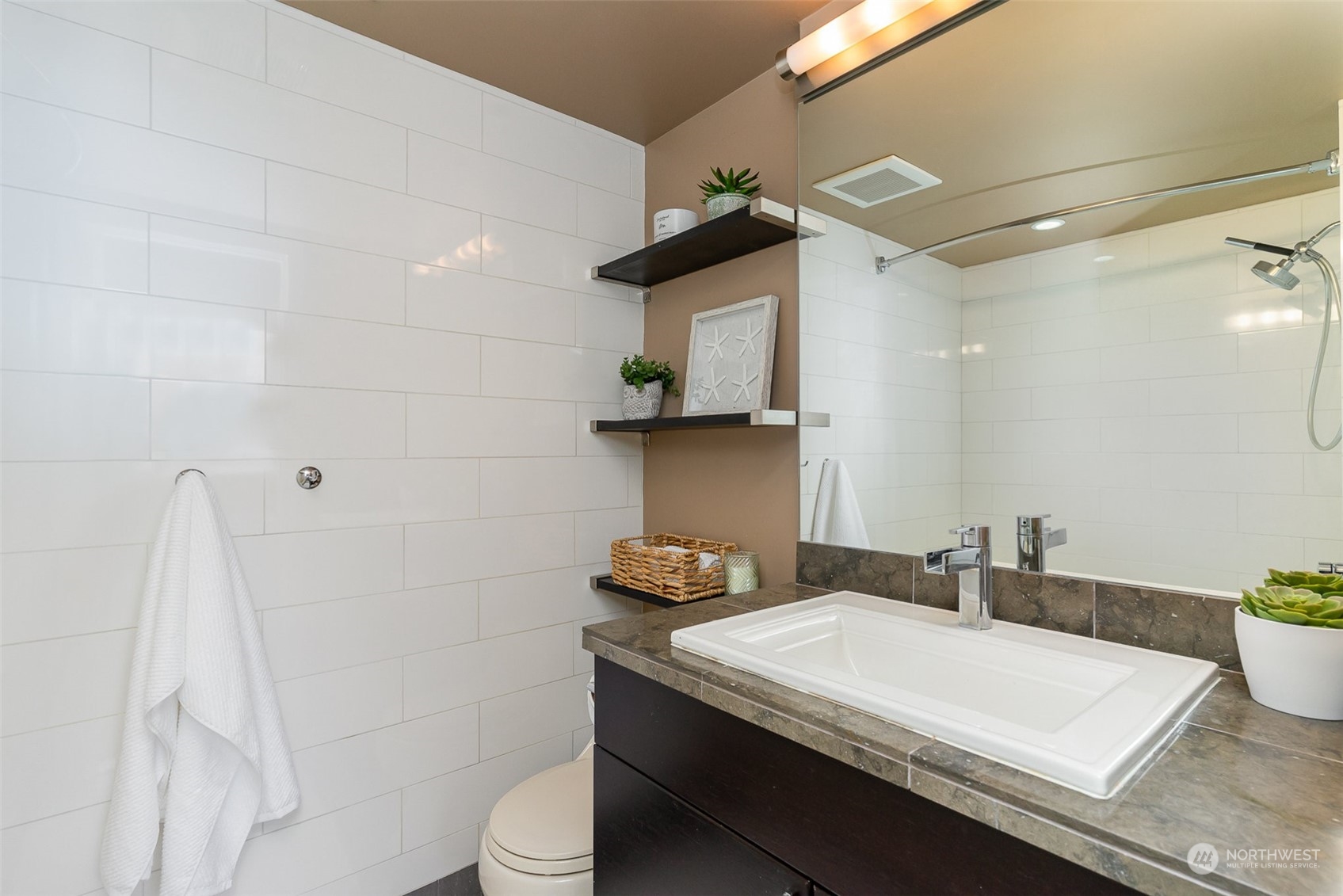1120 8th Avenue, Unit 1601 Seattle, WA 98101 - Photo 14 of 30 a bathroom with a sink and a mirror
