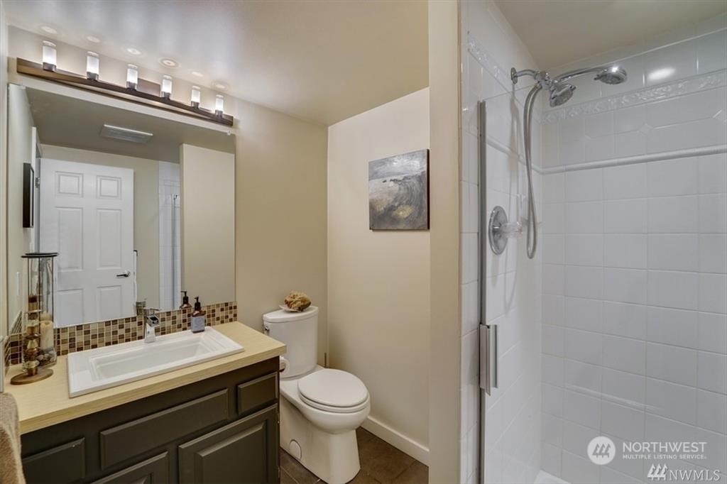 1120 8th Avenue, Unit 1601 Seattle, WA 98101 - Photo 17 of 30 a bathroom with a sink a toilet and shower