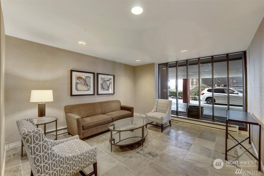 1120 8th Avenue, Unit 1601 Seattle, WA 98101 - Photo 20 of 30 a living room with furniture and a lamp