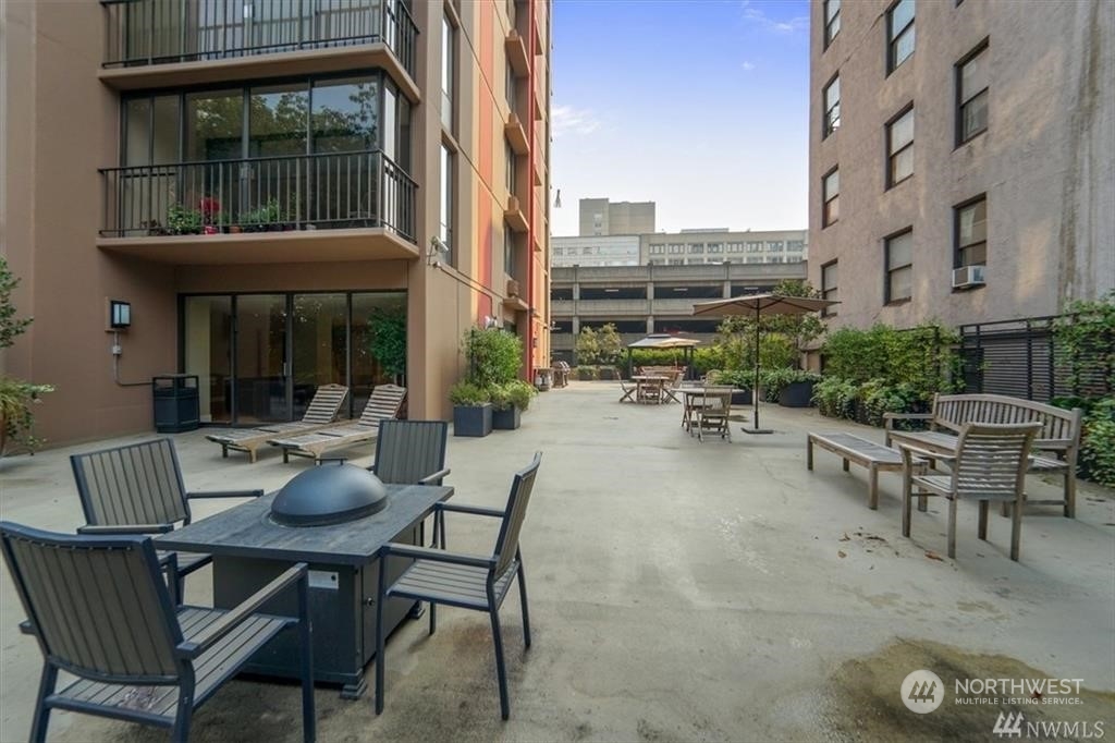 1120 8th Avenue, Unit 1601 Seattle, WA 98101 - Photo 23 of 30 a view of a patio with couches table and chairs and potted plants