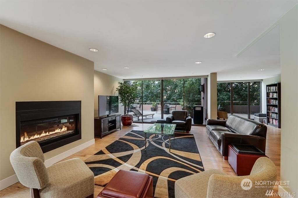1120 8th Avenue, Unit 1601 Seattle, WA 98101 - Photo 25 of 30 a living room with furniture fireplace and a large window