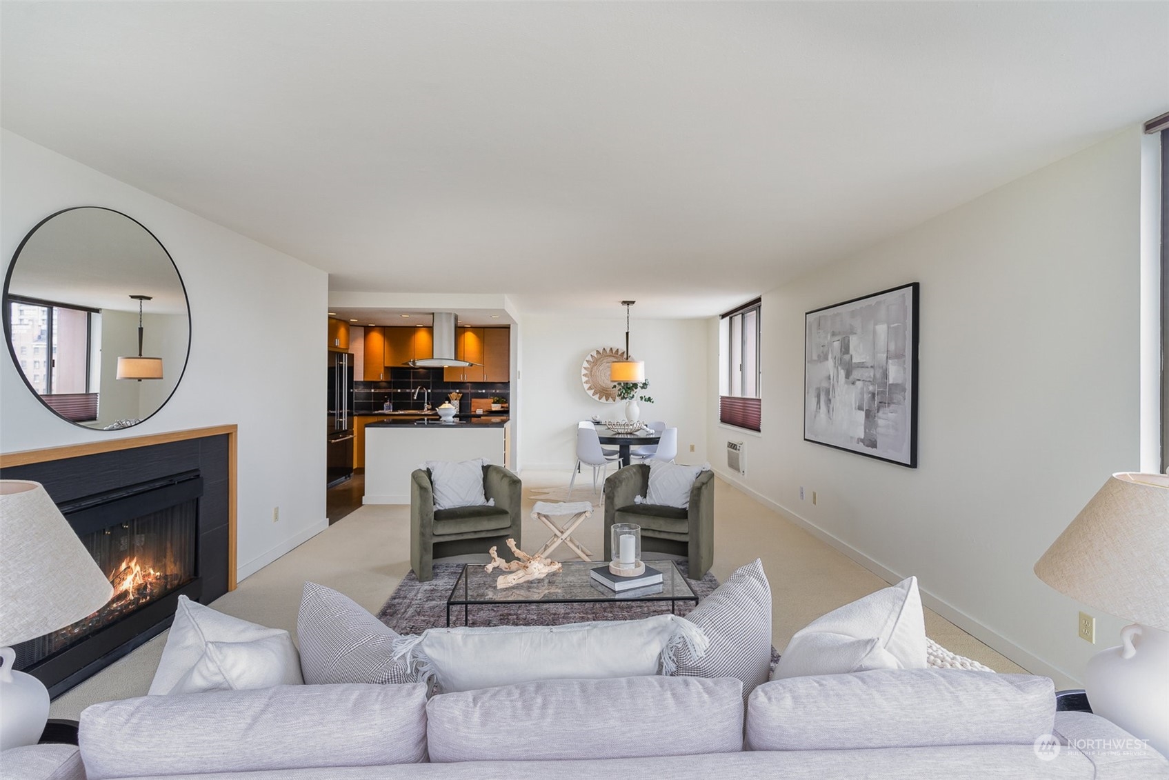 1120 8th Avenue, Unit 1601 Seattle, WA 98101 - Photo 3 of 30 a living room with furniture a fireplace and a flat screen tv