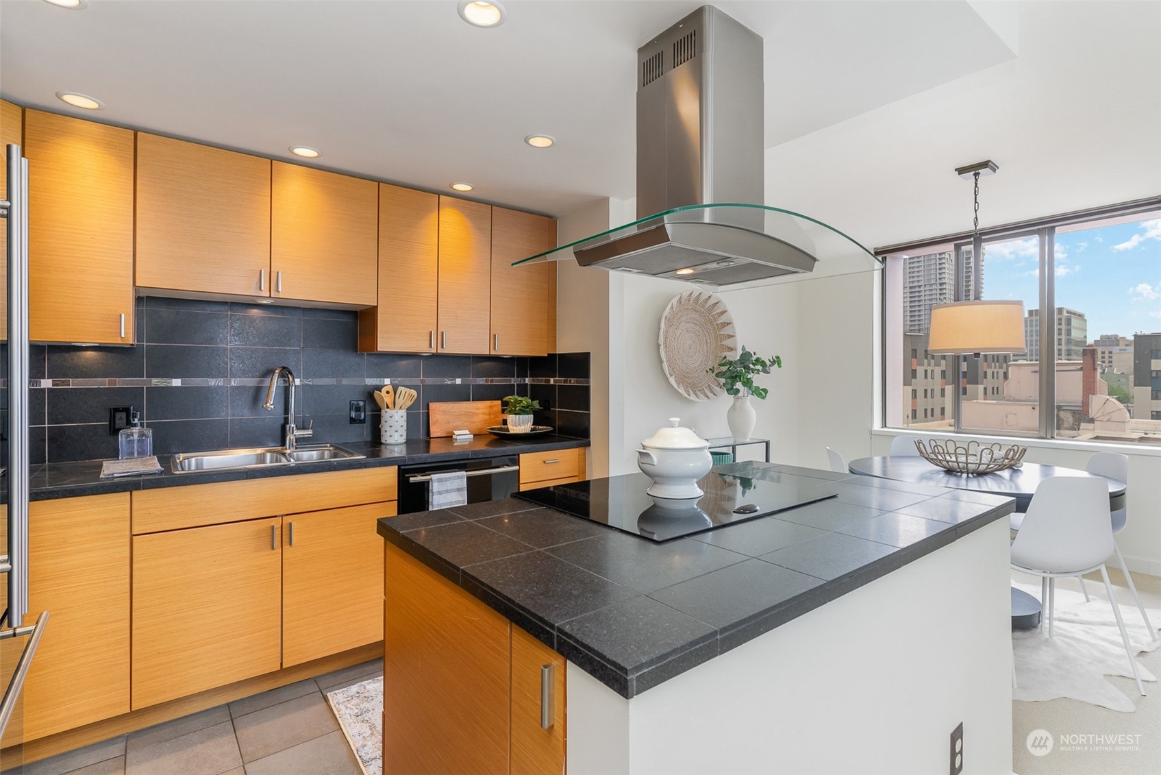 1120 8th Avenue, Unit 1601 Seattle, WA 98101 - Photo 7 of 30 a kitchen with a sink a counter top space and appliances