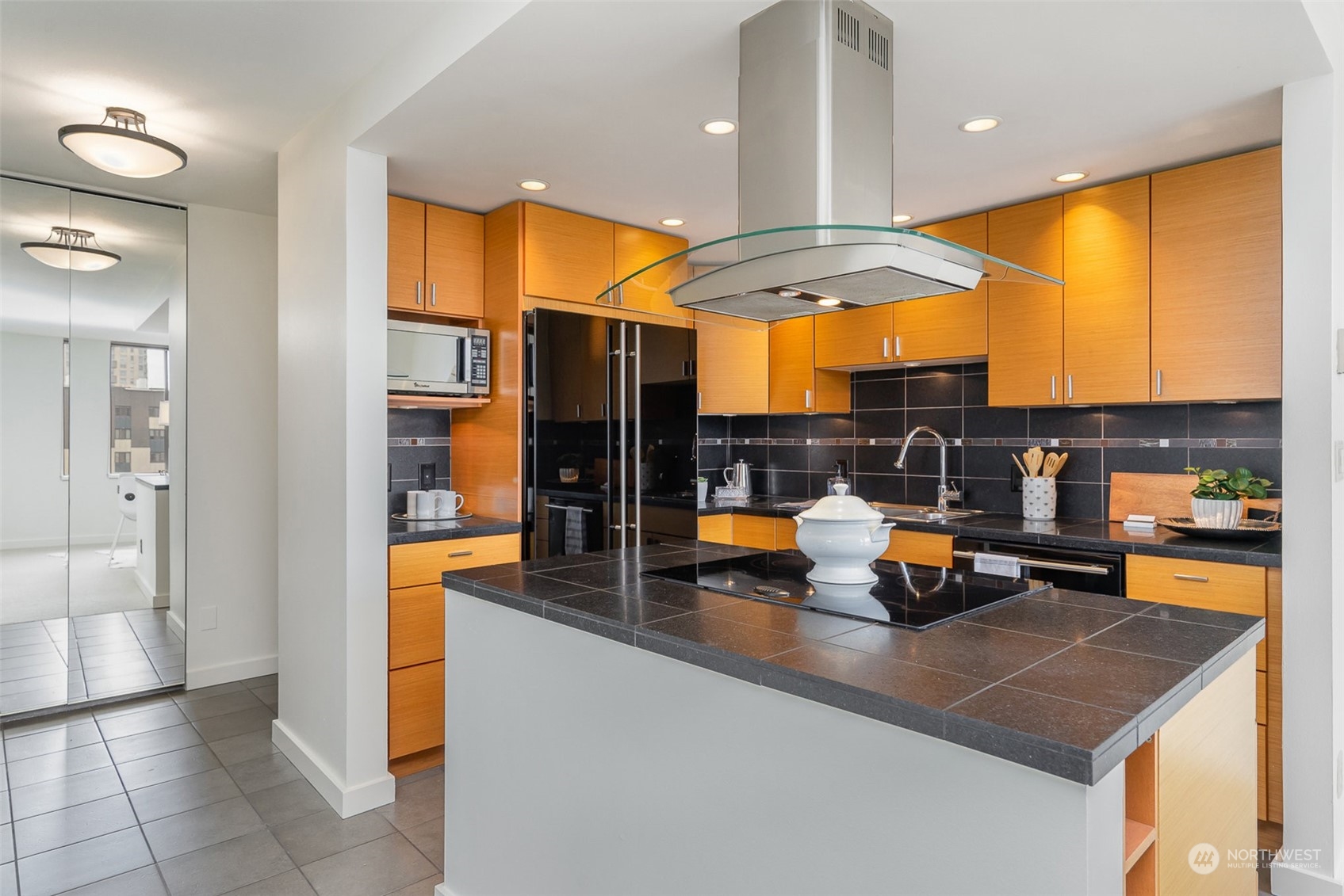 1120 8th Avenue, Unit 1601 Seattle, WA 98101 - Photo 8 of 30 a kitchen with stainless steel appliances granite countertop a sink a refrigerator and a stove