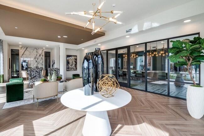 5649 Bois D Arc Road McKinney, TX 75071 - Photo 5 of 7 a living room with furniture a chandelier and a dining table with wooden floor