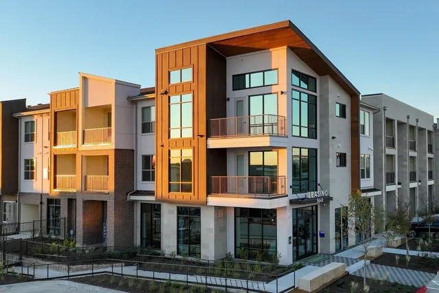 a front view of a residential apartment building with a yard