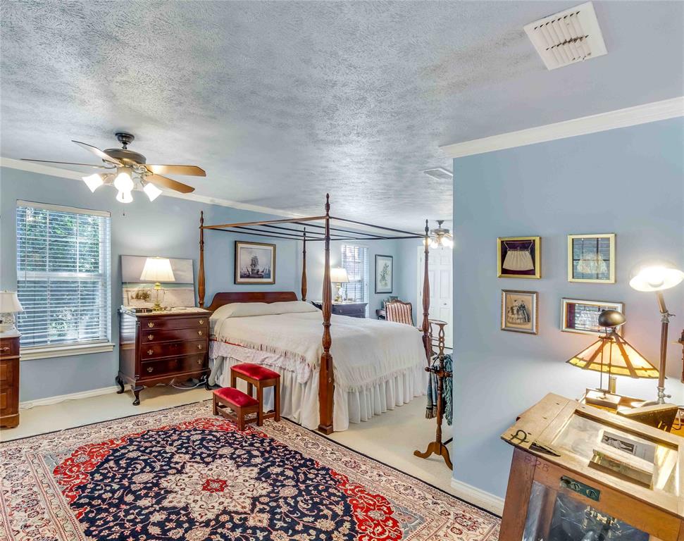 216 McMillen Road Lucas, TX 75002 - Photo 25 of 36 a spacious bedroom with a bed and wooden floor