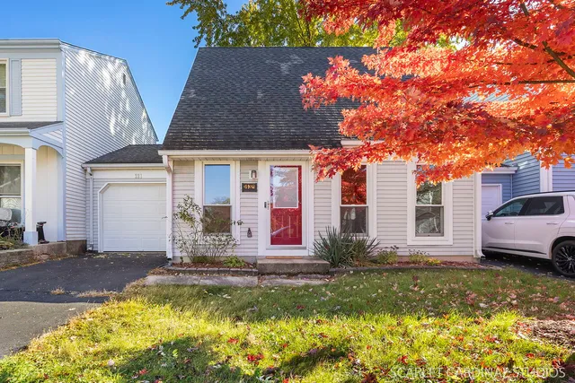 a front view of house with yard play table and chairs