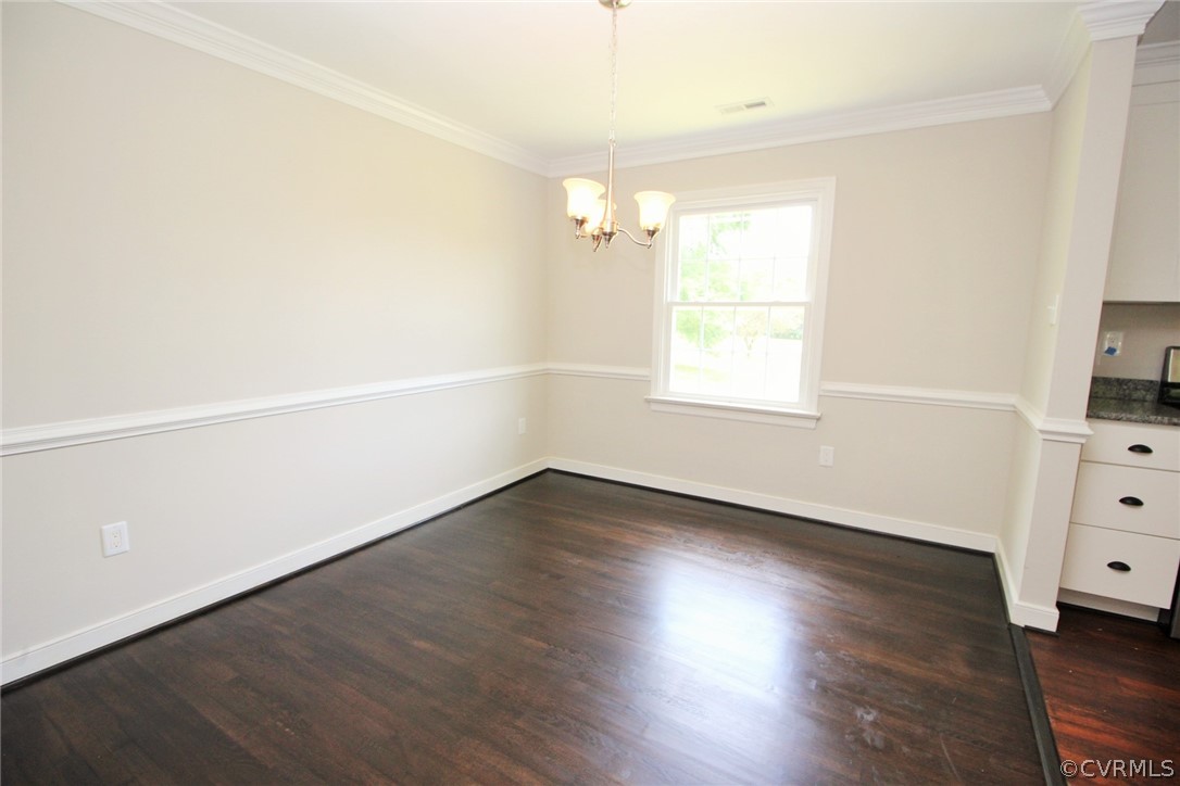 Dining room w/ refinished hardwoods, chair rail &
