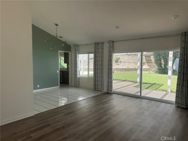 a view of an empty room and wooden door