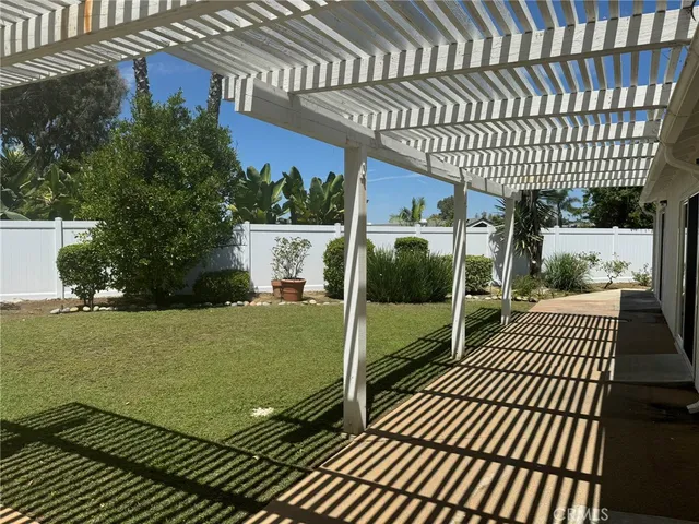 a view of a house with backyard porch and sitting area