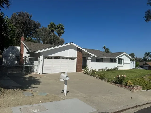a kitchen with a refrigerator and a stove top oven