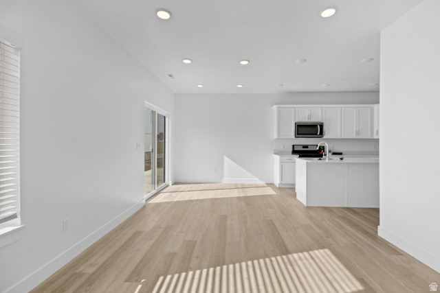 1271 West 500 South Logan, UT 84321 - Photo 5 of 26 Open-concept living area featuring light wood-finish flooring, recessed lighting, and a modern kitchen