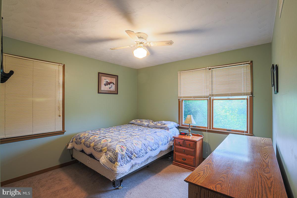 3899 Bixler Church Road Westminster, MD 21158 - Photo 13 of 42 a bedroom with a bed and a night stand