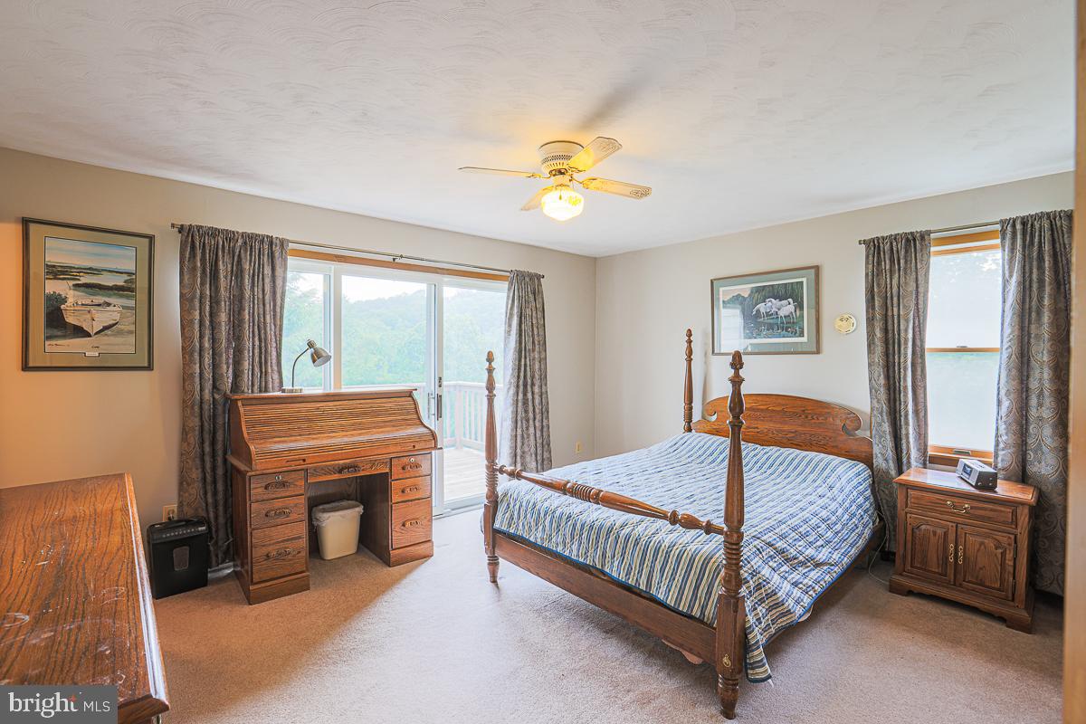 3899 Bixler Church Road Westminster, MD 21158 - Photo 14 of 42 a bedroom with a bed and a chandelier