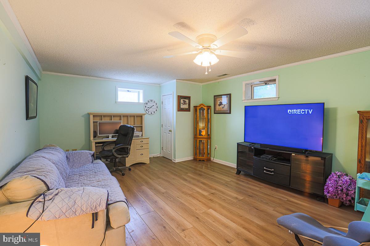 3899 Bixler Church Road Westminster, MD 21158 - Photo 20 of 42 a living room with furniture and a flat screen tv