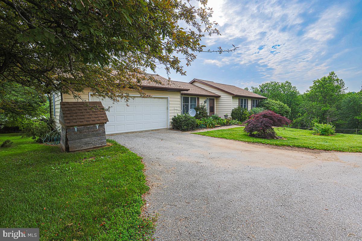3899 Bixler Church Road Westminster, MD 21158 - Photo 2 of 42 a front view of a house with a garden and yard