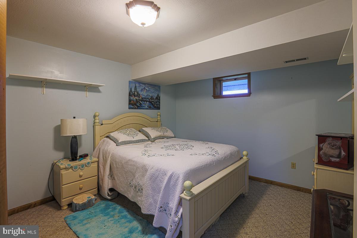 3899 Bixler Church Road Westminster, MD 21158 - Photo 25 of 42 a bedroom with bed and a night stand