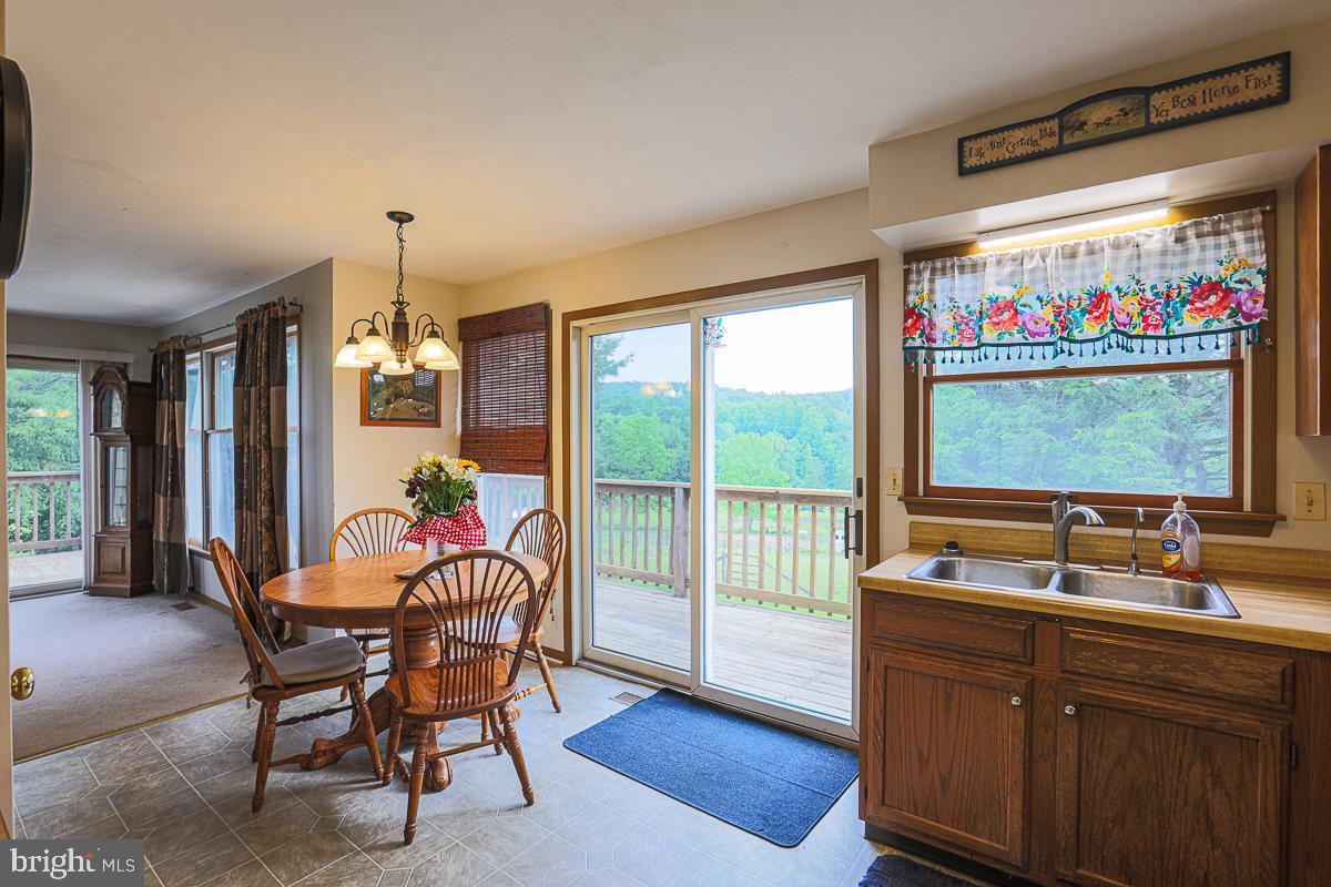 3899 Bixler Church Road Westminster, MD 21158 - Photo 9 of 42 a view of a dining room with furniture water view and wooden floor