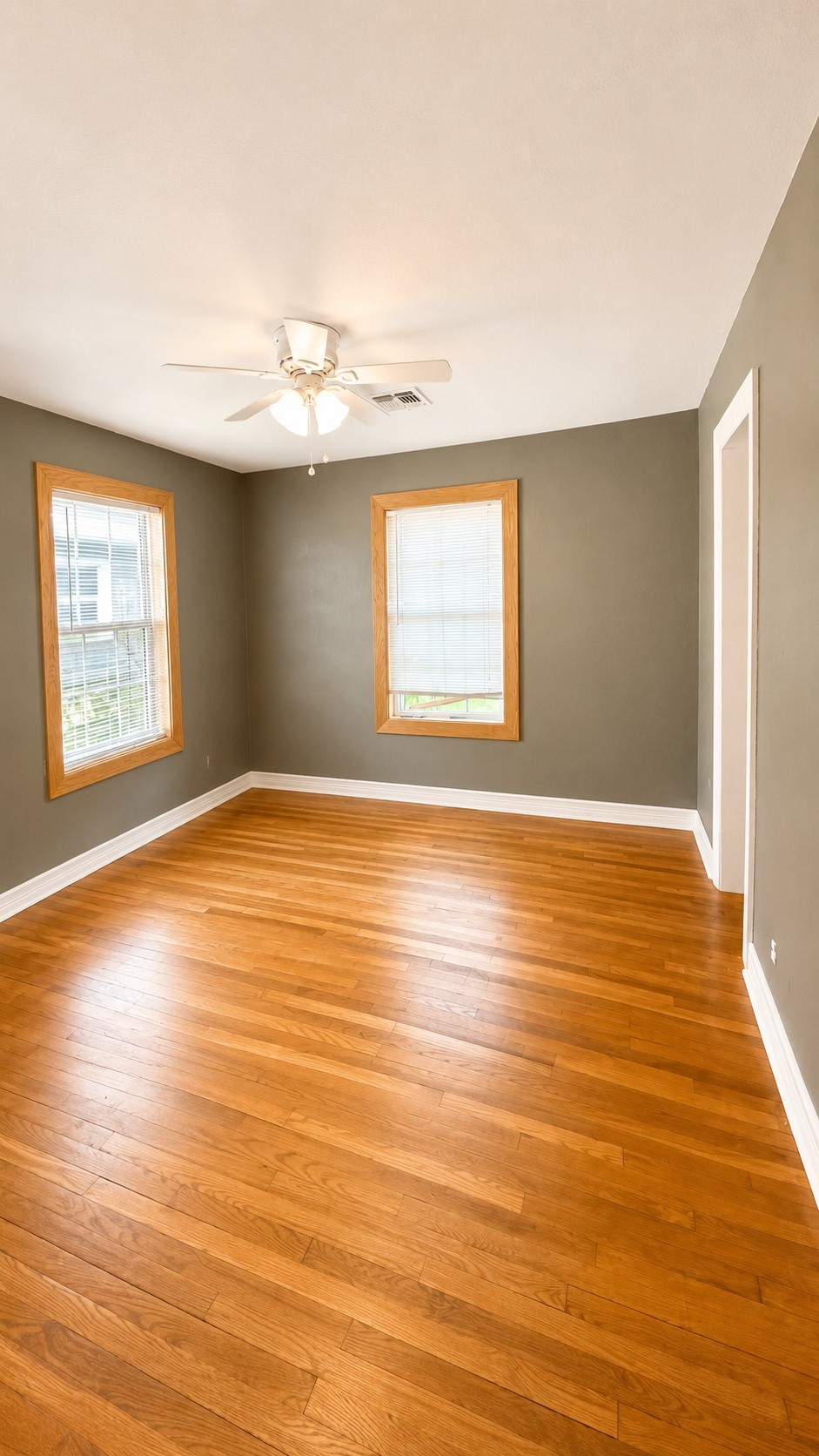 7622 Azalea Street Houston, TX 77023 - Photo 3 of 10 Large bedroom 1 with original hardwood floors, updated paint, and plenty of natural light.