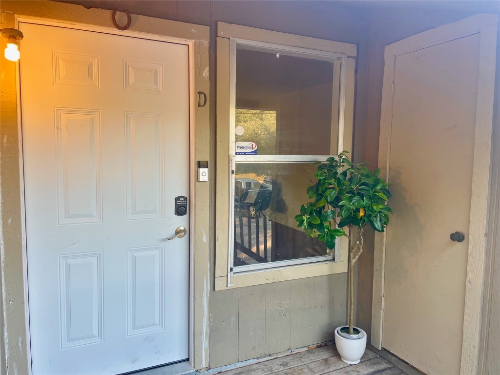 402 Hedgewood Drive, Unit D Georgetown, TX 78628 - Photo 1 of 1 a view of a glass door with a glass door and a window