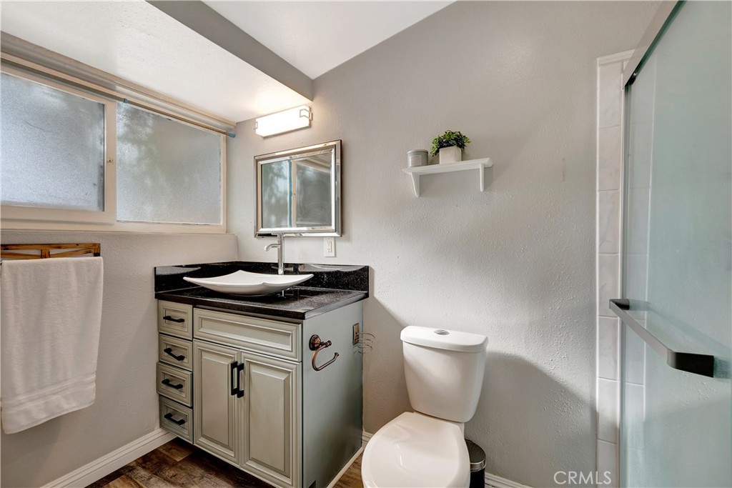1770 Wright Street Pomona, CA 91766 - Photo 20 of 70 a bathroom with a granite countertop toilet sink and mirror