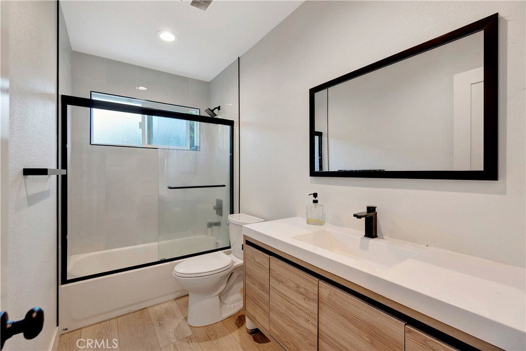 1770 Wright Street Pomona, CA 91766 - Photo 39 of 70 a bathroom with a toilet a sink and a mirror