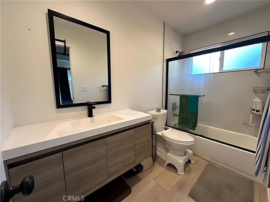 1770 Wright Street Pomona, CA 91766 - Photo 42 of 70 a bathroom with a toilet a sink and mirror