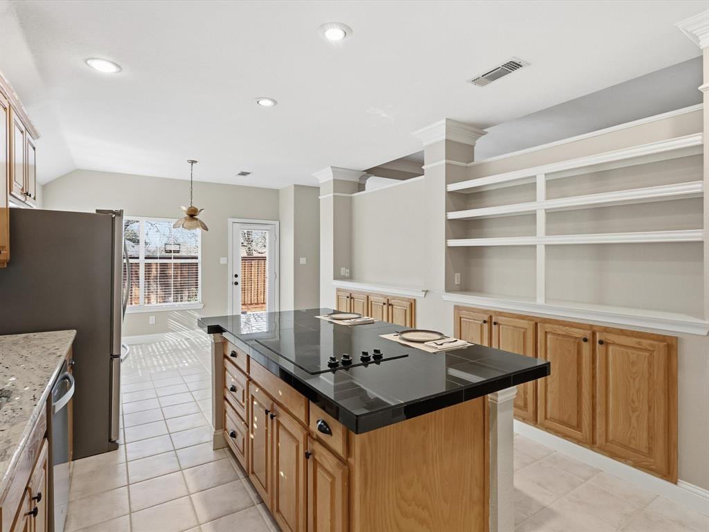 2211 Post Oak Circle Corinth, TX 76210 - Photo 14 of 40 a kitchen with granite countertop a sink stove and refrigerator