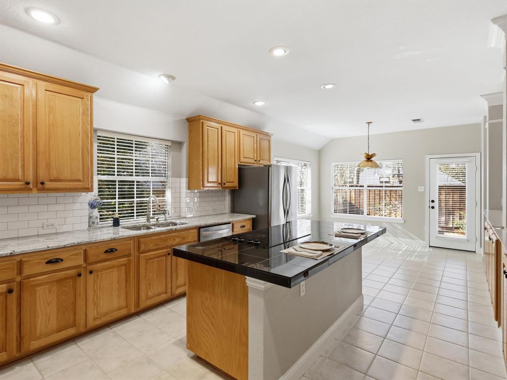 2211 Post Oak Circle Corinth, TX 76210 - Photo 15 of 40 a kitchen with stainless steel appliances granite countertop a sink stove and cabinets