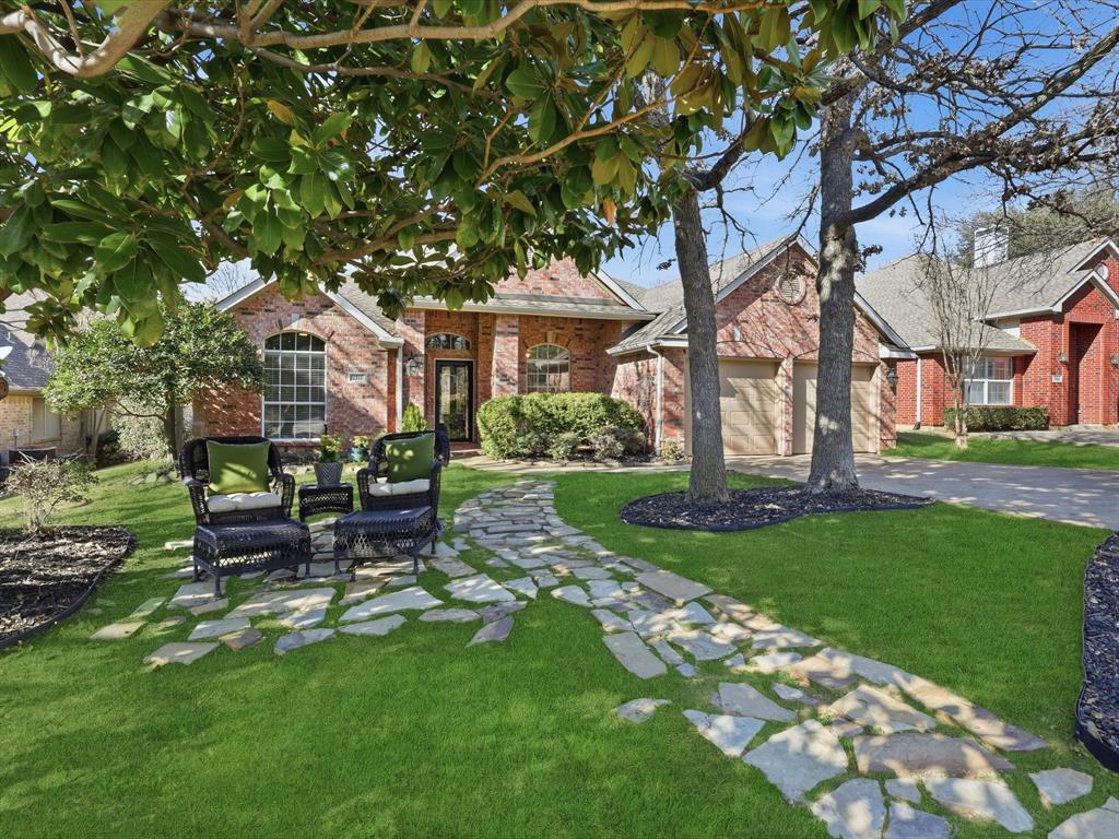 2211 Post Oak Circle Corinth, TX 76210 - Photo 2 of 40 a view of a house with backyard sitting area and garden