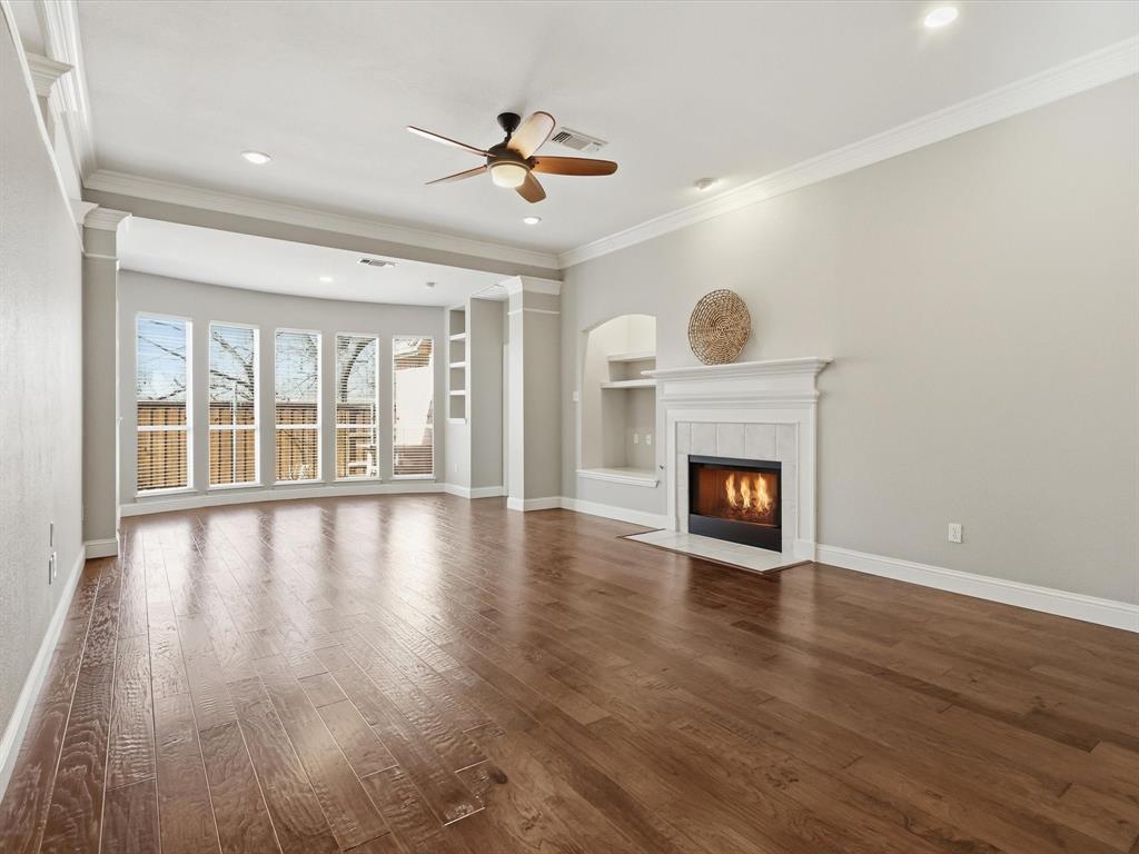 2211 Post Oak Circle Corinth, TX 76210 - Photo 20 of 40 a view of an empty room with a fireplace and wooden floor