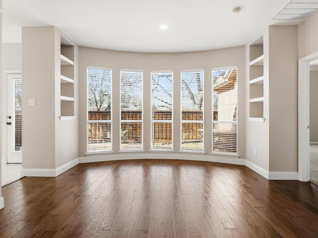 2211 Post Oak Circle Corinth, TX 76210 - Photo 23 of 40 a view of an empty room with wooden floor and a window
