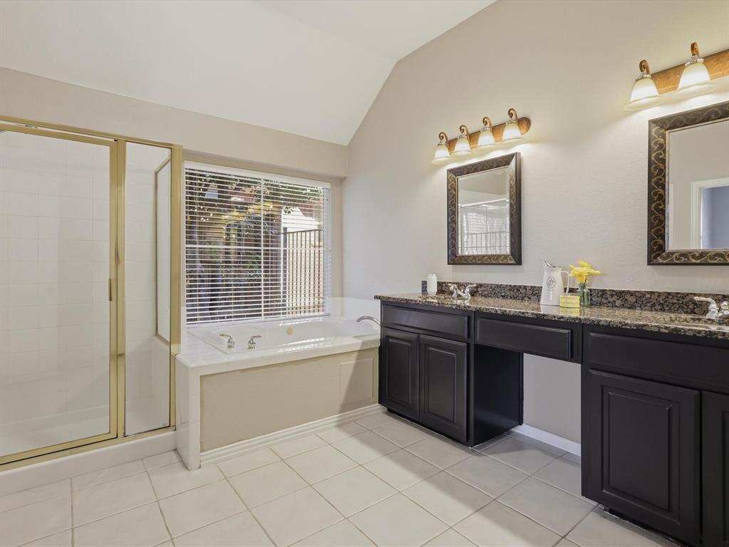 2211 Post Oak Circle Corinth, TX 76210 - Photo 29 of 40 a bathroom with a granite countertop bathtub sink vanity and mirror