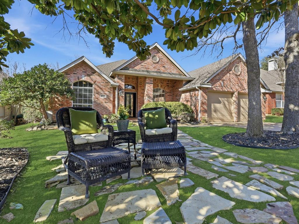 2211 Post Oak Circle Corinth, TX 76210 - Photo 3 of 40 a patio with a table and chairs and a fire pit