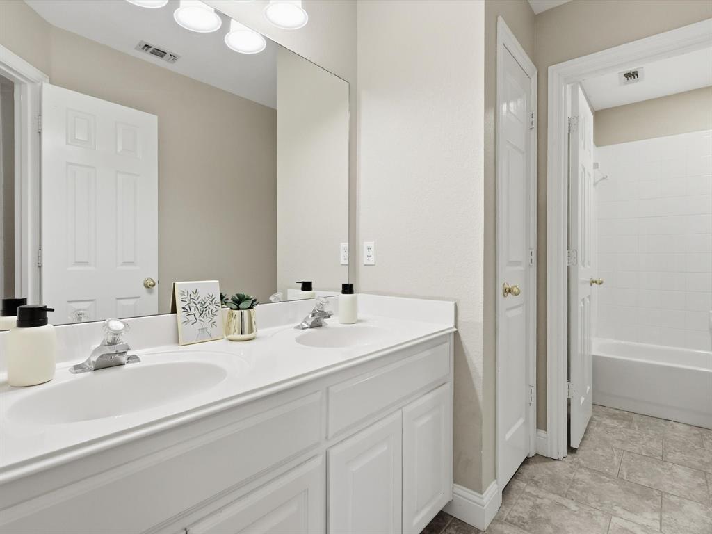 2211 Post Oak Circle Corinth, TX 76210 - Photo 33 of 40 a bathroom with double sink and a mirror
