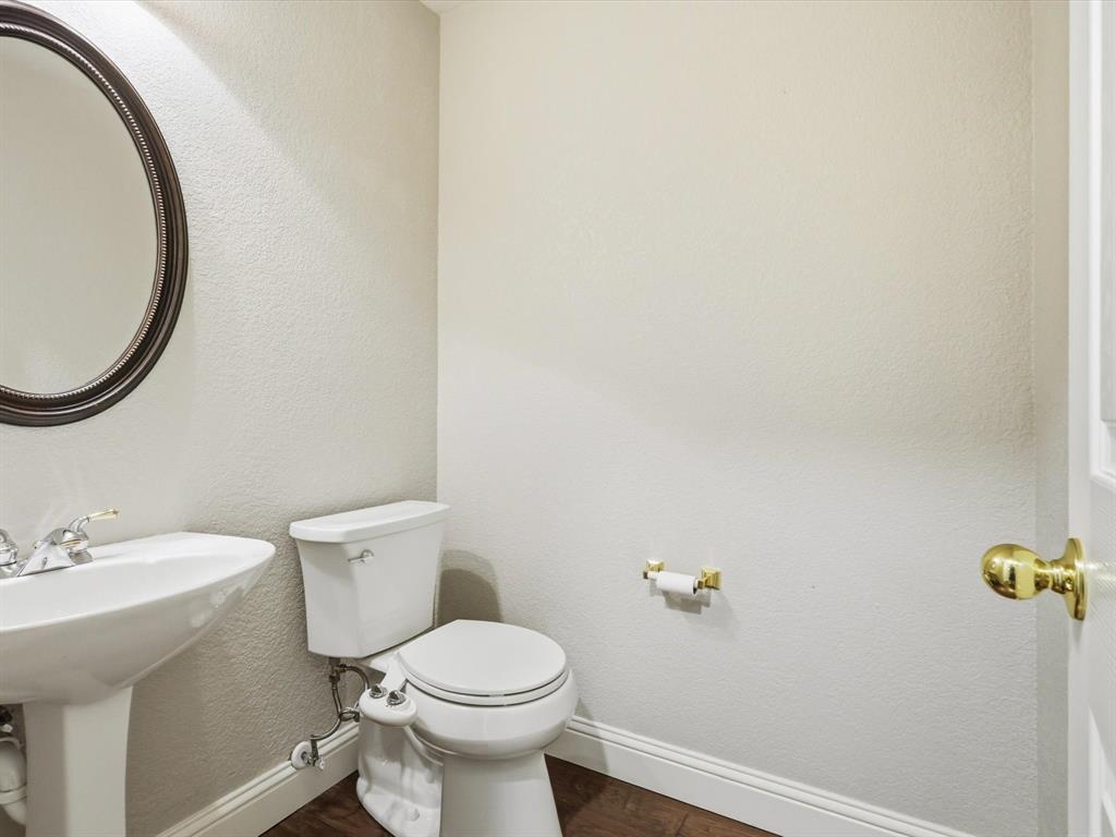 2211 Post Oak Circle Corinth, TX 76210 - Photo 35 of 40 a bathroom with a sink mirror and toilet