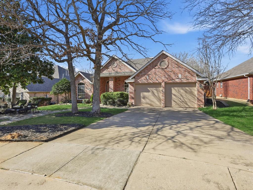 2211 Post Oak Circle Corinth, TX 76210 - Photo 4 of 40 a front view of a house with a yard and garage