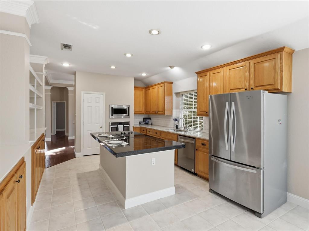 2211 Post Oak Circle Corinth, TX 76210 - Photo 9 of 40 a kitchen with stainless steel appliances granite countertop a refrigerator a sink a stove and a refrigerator