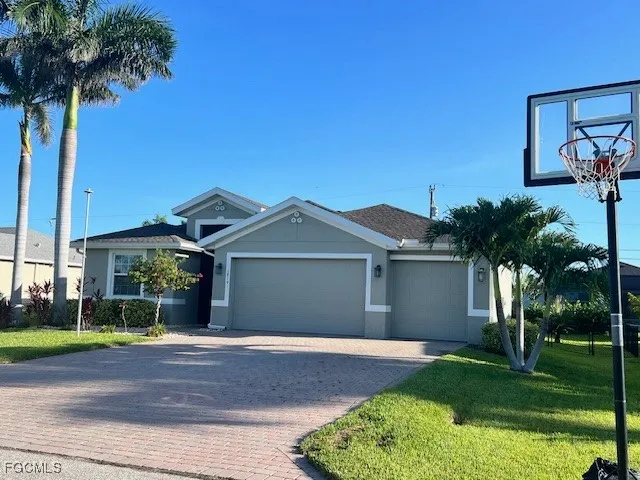 a front view of a house with a yard and garage