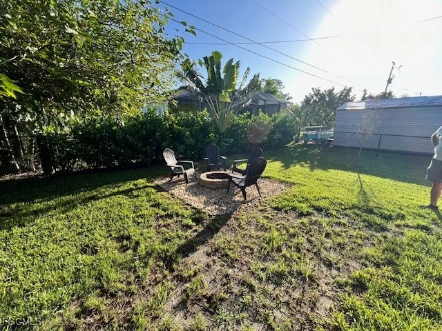 a view of a swimming pool with a bench and trees