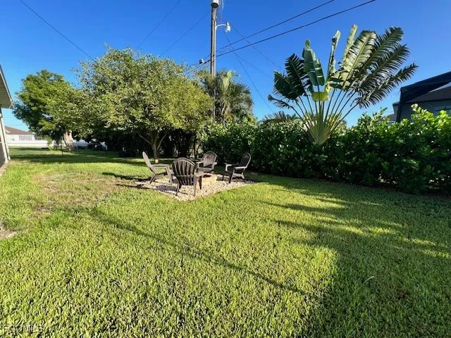 a view of a chair and table on the garden