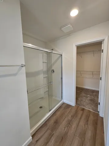 a bathroom with a glass shower door