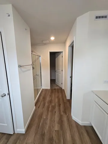 a view of hallway with wooden floor