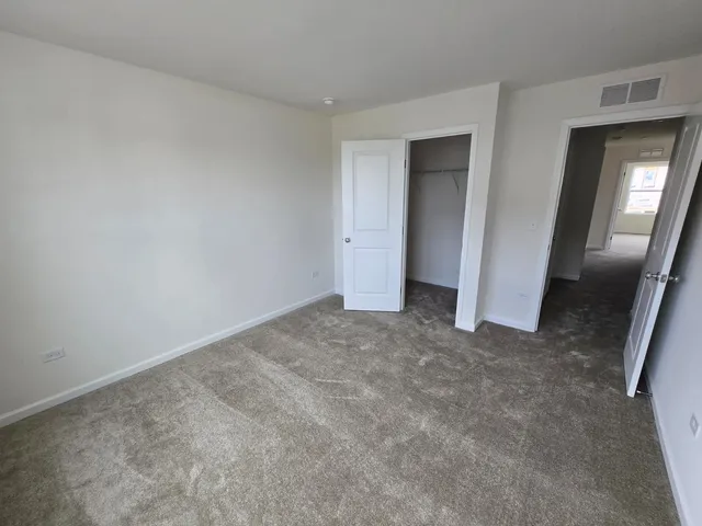 a view of an empty room and closet area